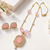 Pink stone pendant necklace and earrings jewellery set gold-tone chain, crystal embellished, pearl accents, rectangular.