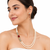 Double strand pearl necklace and earring set with ruby stone cz diamond accents, gold-tone finish, side brooch design