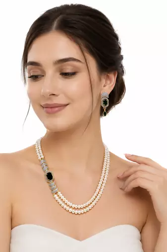 Pearl necklace & earring set with emerald green cz stone 2-layer strand, side brooch design, gold-tone bridal jewellery.