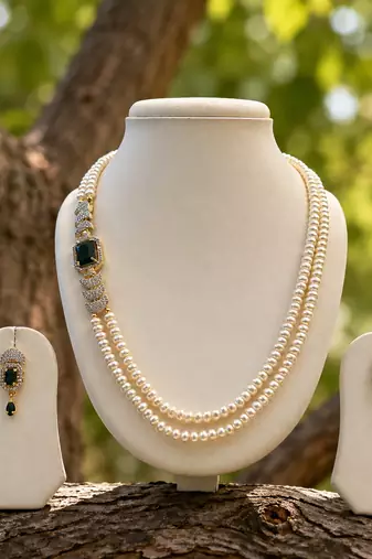 Pearl necklace & earring set with emerald green cz stone 2-layer strand, side brooch design, gold-tone bridal jewellery.