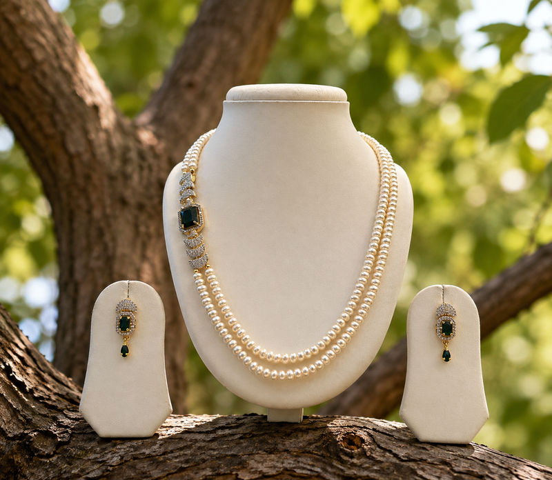 Pearl necklace & earring set with emerald green cz stone 2-layer strand, side brooch design, gold-tone bridal jewellery.