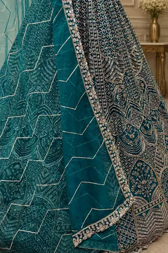 teal color Fancy Patten and Motif Crystal and Sequince work net Lehenga Choli set