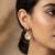 gold plated floral motif ruby and white stone drop earrings