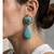 Gold plated turquoise blue stone dangler earrings