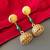 Gold plated green drop jhumka earrrings