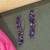 Gold plated purple drop dangler earrings