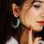 Gold plated beaded blue dangler drop earrings
