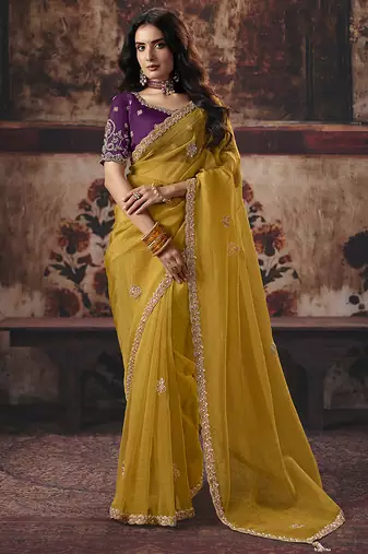 Mustard yellow faux organza saree with zari embroidered border & purple blouse
