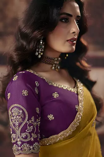 Mustard yellow faux organza saree with zari embroidered border & purple blouse