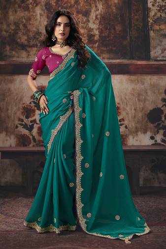 Teal green faux chiffon saree with zari embroidered border & magenta pink blouse
