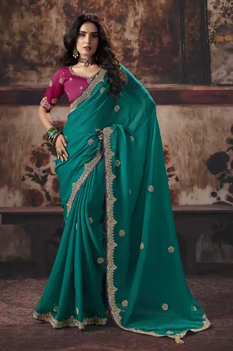 Teal green faux chiffon saree with zari embroidered border & magenta pink blouse