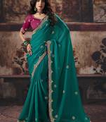 Teal green faux chiffon saree with zari embroidered border & magenta pink blouse