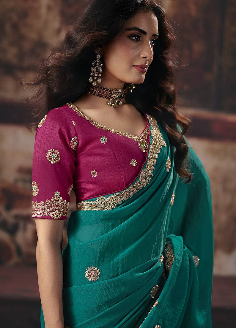 Teal green faux chiffon saree with zari embroidered border & magenta pink blouse