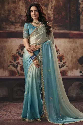 Cream & sky blue faux satin shimmer saree with embroidered blouse