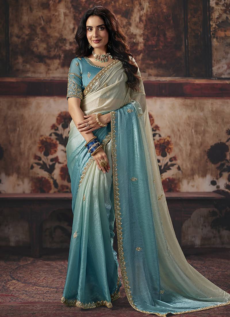 Cream & sky blue faux satin shimmer saree with embroidered blouse
