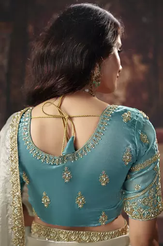 Cream & sky blue faux satin shimmer saree with embroidered blouse