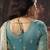Cream & sky blue faux satin shimmer saree with embroidered blouse