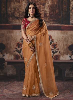 Orange shimmer faux organza saree with maroon embroidered blouse 1