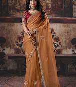 Orange shimmer faux organza saree with maroon embroidered blouse