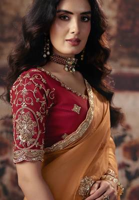 Orange shimmer faux organza saree with maroon embroidered blouse 2