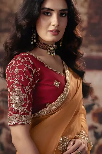 Orange shimmer faux organza saree with maroon embroidered blouse