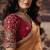 Orange shimmer faux organza saree with maroon embroidered blouse