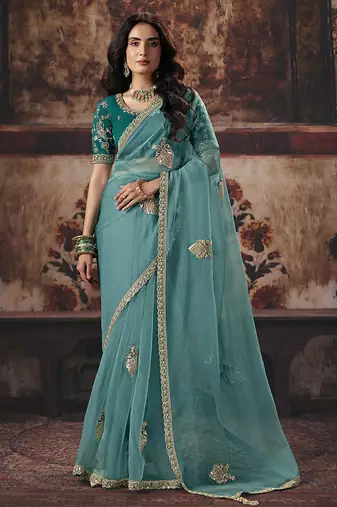 Sea green shimmer faux organza saree with embroidered blouse