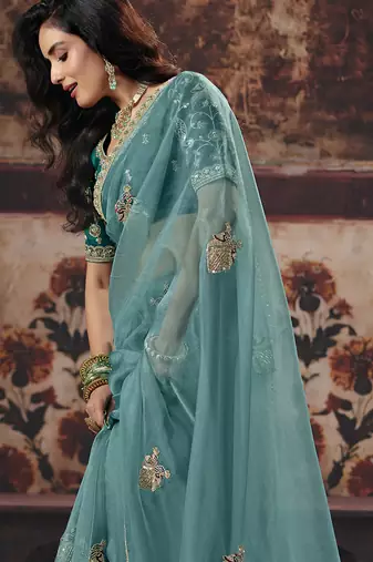 Sea green shimmer faux organza saree with embroidered blouse
