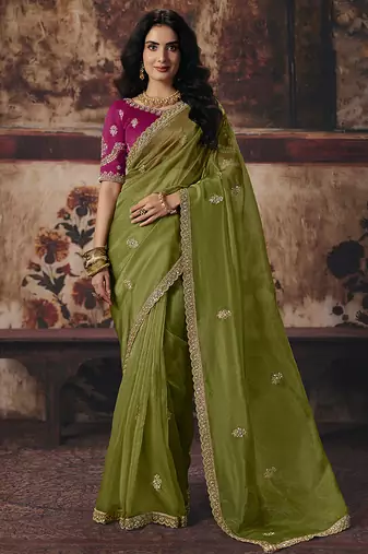 Olive green shimmer faux organza saree with rani pink embroidered blouse