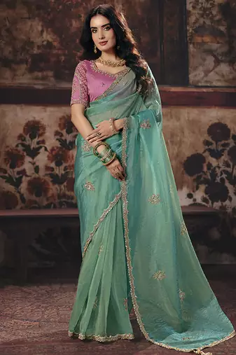 Sea green shimmer faux organza saree with pink embroidered blouse