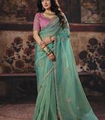 Sea green shimmer faux organza saree with pink embroidered blouse