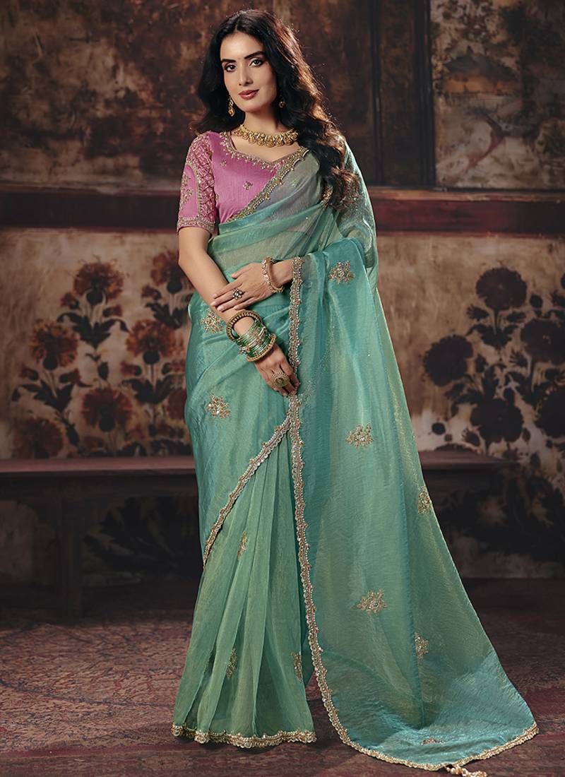 Sea green shimmer faux organza saree with pink embroidered blouse