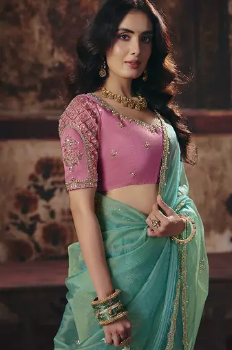 Sea green shimmer faux organza saree with pink embroidered blouse