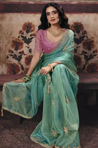 Sea green shimmer faux organza saree with pink embroidered blouse