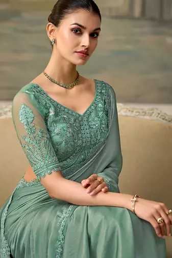 Sea green faux chiffon saree with embroidered blouse