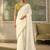 Off-white faux georgette saree with embroidered olive tussar blouse