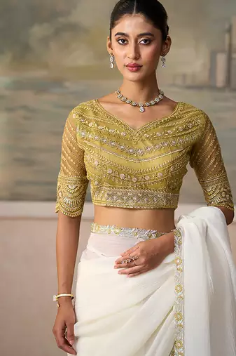 Off-white faux georgette saree with embroidered olive tussar blouse