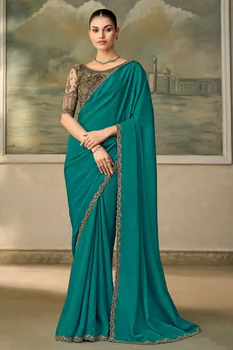 Teal faux georgette saree with embroidered antique gold blouse