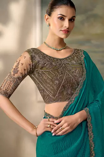 Teal faux georgette saree with embroidered antique gold blouse