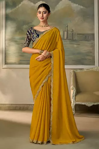 Mustard yellow faux georgette saree with embroidered navy blue blouse