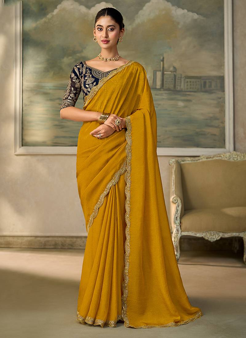 Mustard yellow faux georgette saree with embroidered navy blue blouse