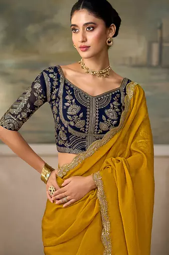 Mustard yellow faux georgette saree with embroidered navy blue blouse