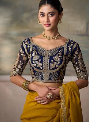 Mustard yellow faux georgette saree with embroidered navy blue blouse 3