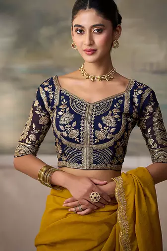 Mustard yellow faux georgette saree with embroidered navy blue blouse