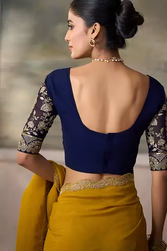 Mustard yellow faux georgette saree with embroidered navy blue blouse
