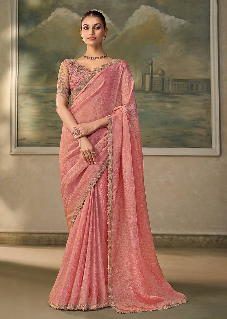 Peach pink faux tissue saree with embroidered blouse