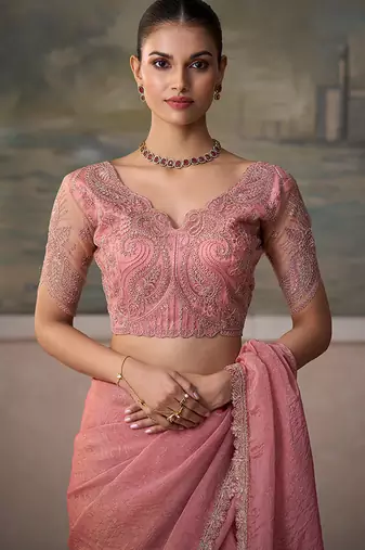 Peach pink faux tissue saree with embroidered blouse