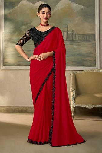 Red faux chiffon saree with black embroidered border and  blouse