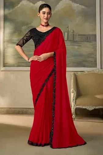 Red faux chiffon saree with black embroidered border and  blouse