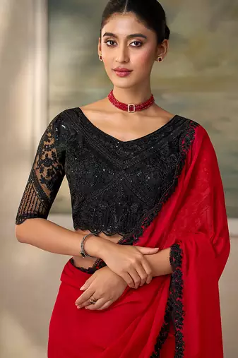 Red faux chiffon saree with black embroidered border and  blouse